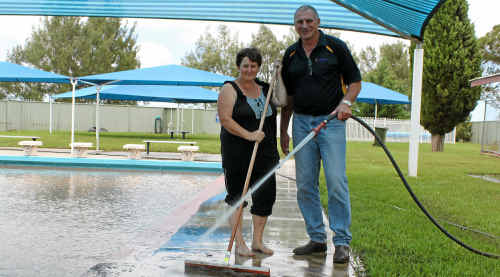 Killarney pool manager Tara Clarke and WIRAC centre manager Don Warrener hose out the Condamine River mud. Killarney pool manager Tara Clarke and WIRAC centre manager Don Warrener hose out the Condamine River mud.